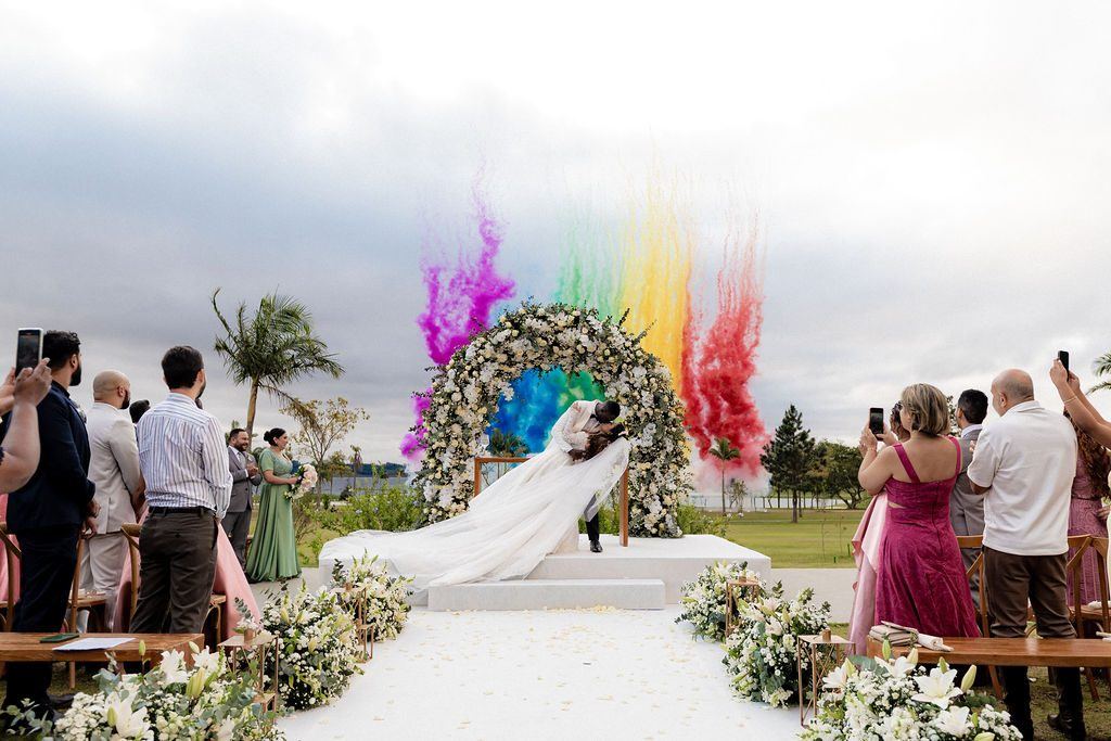 Saída dos noivos com fumaça colorida e pétalas